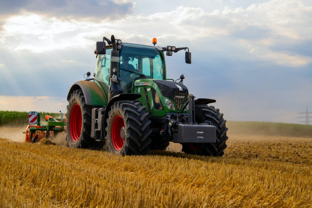Tractor harvesting wheat on Nebraska Farm Land